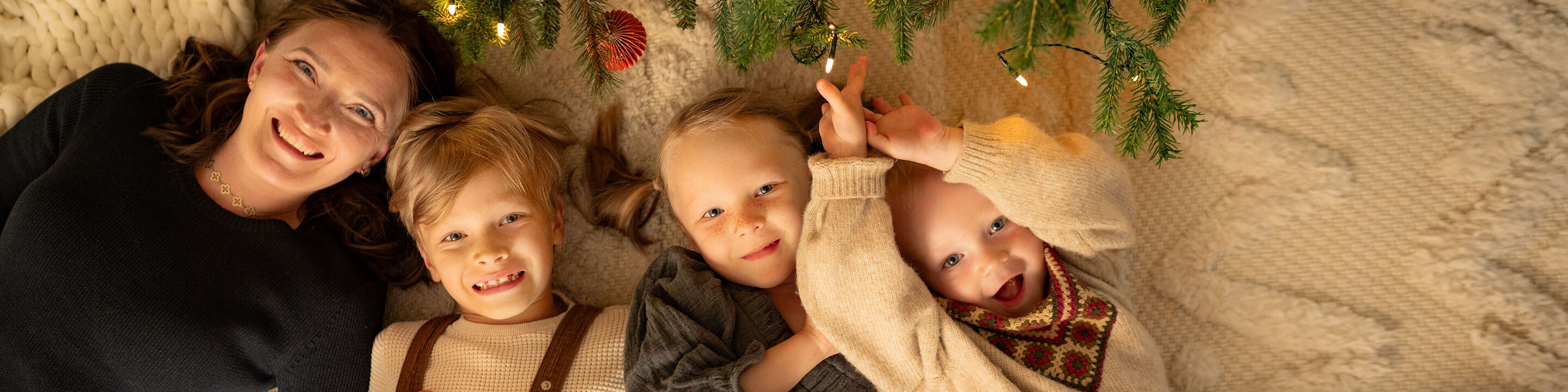 Familienmitgliedschaften in gemütlicher Weihnachtsatmosphäre, umgeben von Lichtern.